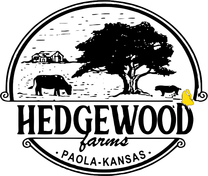 logo_black Logo of Hedgewood Farms, located in Paola, Kansas, featuring a tree, farm animals including a cow and a sheep, and a rustic farmhouse design. The logo emphasizes the farm's agricultural heritage and community roots.